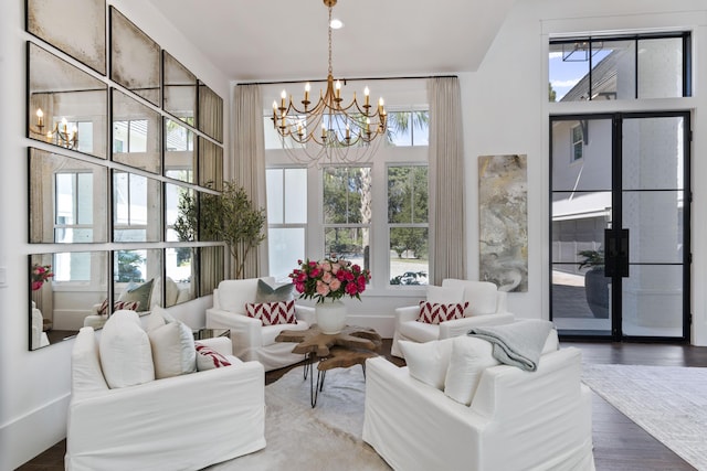 living room with wood finished floors and an inviting chandelier
