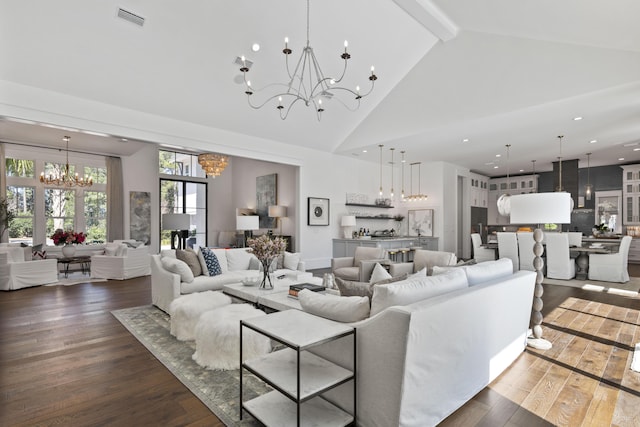 living room with high vaulted ceiling, wood finished floors, beamed ceiling, a notable chandelier, and visible vents