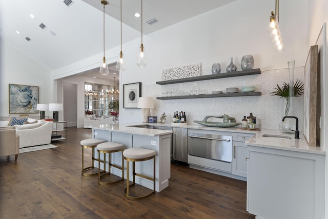bar featuring a sink, decorative backsplash, dishwasher, a notable chandelier, and visible vents