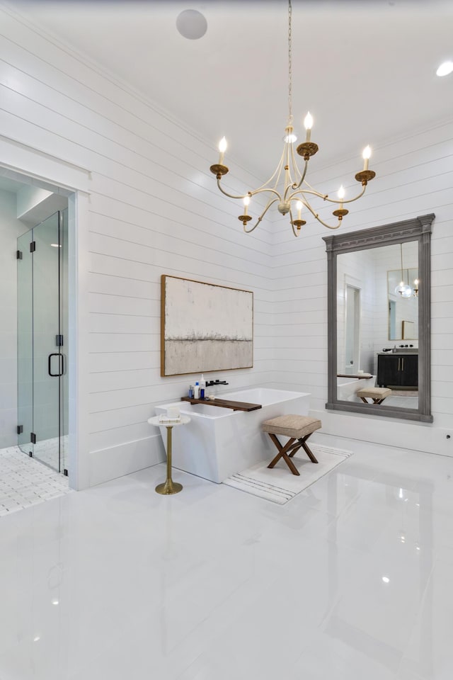 bathroom with tile patterned floors, a freestanding bath, a chandelier, a shower stall, and ornamental molding