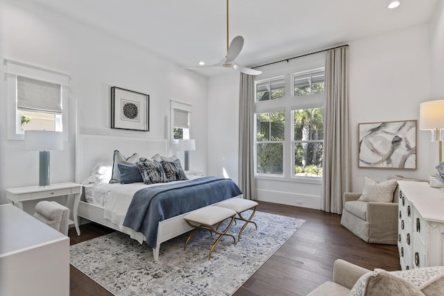 bedroom featuring multiple windows, dark wood-style floors, and recessed lighting