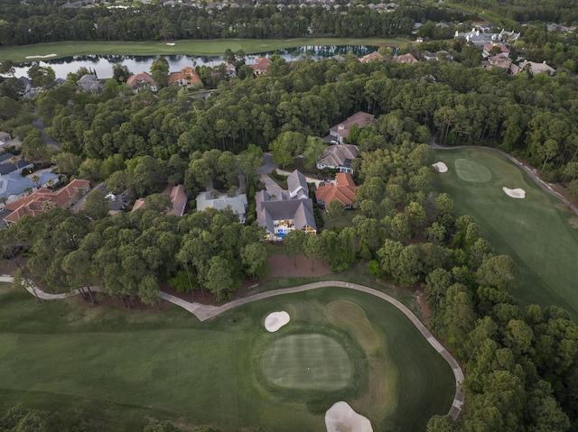drone / aerial view featuring view of golf course, a water view, and a residential view
