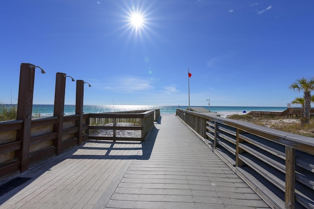 view of dock with a view of the beach and a water view