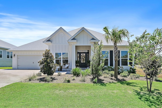 24 Palmer Ln, Santa Rosa Beach, FL 32459 - view of front of home with driveway, board and batten siding, a front lawn, a shingled roof, and a garage
