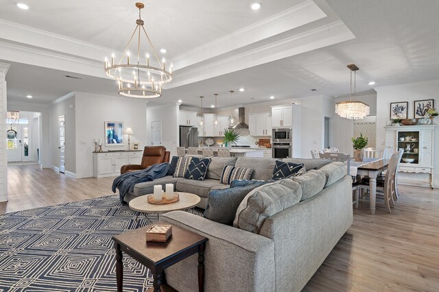 24 Palmer Ln, Santa Rosa Beach, FL 32459 - living room with a notable chandelier, light wood-style floors, recessed lighting, and a raised ceiling