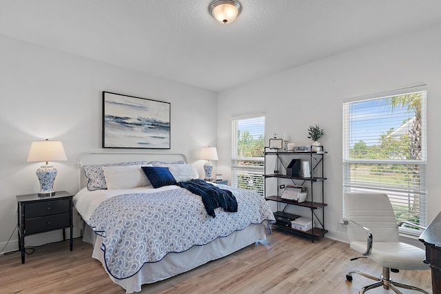 24 Palmer Ln, Santa Rosa Beach, FL 32459 - bedroom featuring baseboards and light wood-style flooring