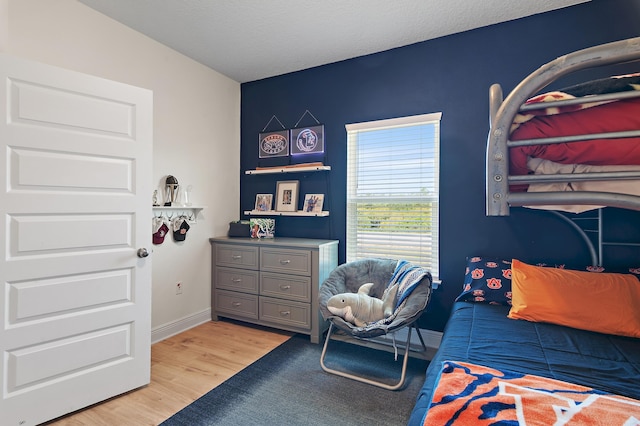 24 Palmer Ln, Santa Rosa Beach, FL 32459 - bedroom with baseboards, a textured ceiling, and light wood-style floors