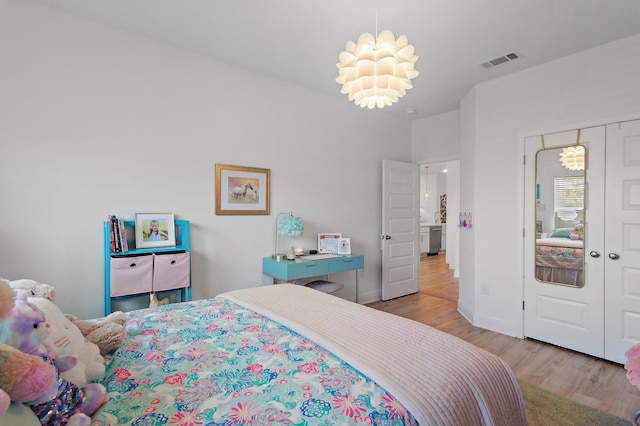24 Palmer Ln, Santa Rosa Beach, FL 32459 - bedroom with a closet, baseboards, visible vents, and wood finished floors