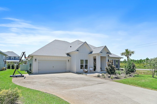 24 Palmer Ln, Santa Rosa Beach, FL 32459 - modern farmhouse style home featuring a front lawn, driveway, an attached garage, and board and batten siding