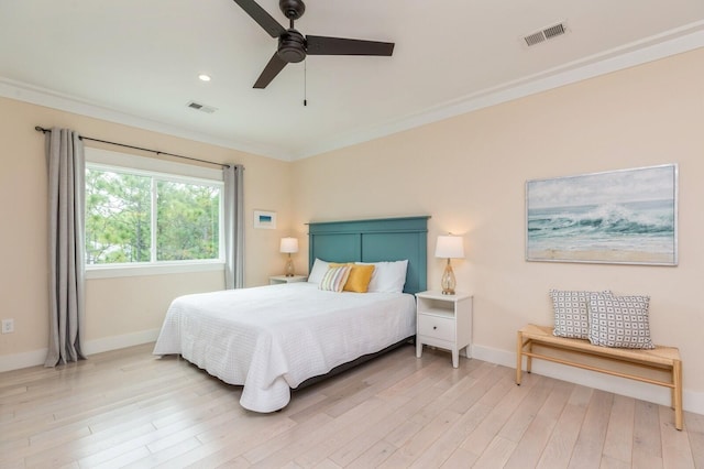 bedroom featuring baseboards, ornamental molding, visible vents, and light wood-style floors