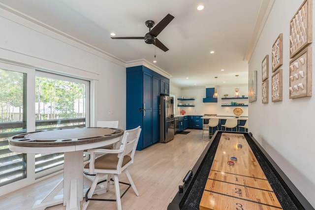 rec room featuring ornamental molding, recessed lighting, a ceiling fan, and light wood finished floors