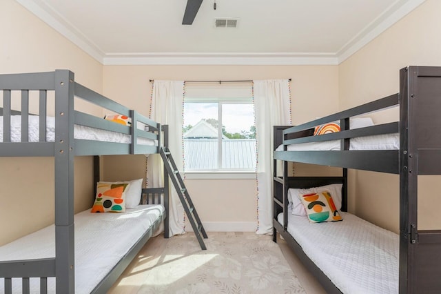 bedroom with crown molding, baseboards, and visible vents
