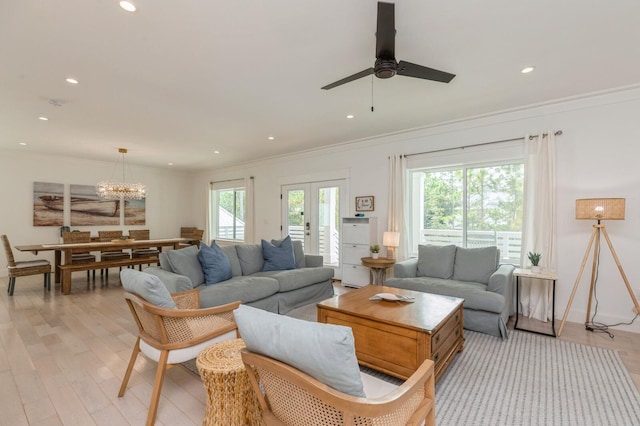 living room featuring recessed lighting, crown molding, and ceiling fan with notable chandelier