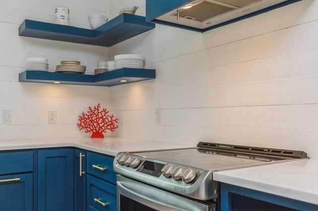 kitchen with light countertops, blue cabinetry, electric stove, open shelves, and ventilation hood