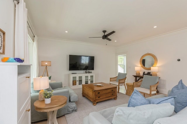 living room featuring a ceiling fan, crown molding, light colored carpet, and recessed lighting