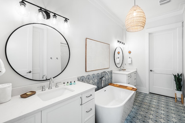 full bathroom featuring a freestanding tub, two vanities, a sink, and visible vents