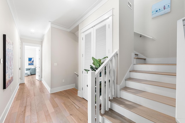 stairway with baseboards, ornamental molding, recessed lighting, visible vents, and wood finished floors
