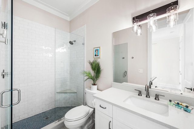 bathroom with ornamental molding, toilet, a shower stall, and vanity