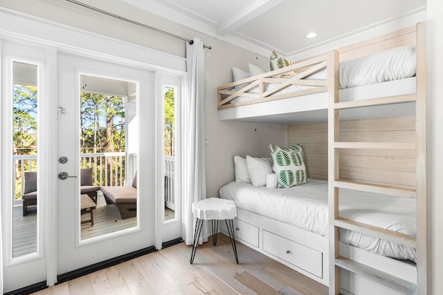 bedroom featuring beamed ceiling, recessed lighting, light wood finished floors, french doors, and access to outside