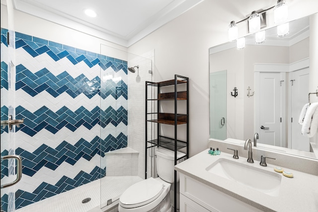 bathroom with crown molding, toilet, a stall shower, and vanity