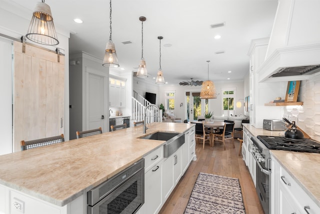 kitchen featuring white cabinets, a sink, visible vents, and stainless steel appliances