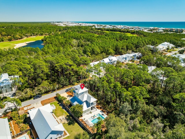 aerial view featuring a water view and a forest view