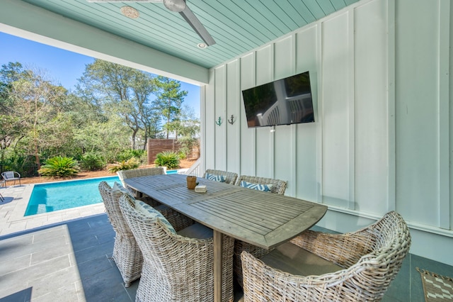 view of patio / terrace featuring a fenced in pool, outdoor dining area, and ceiling fan