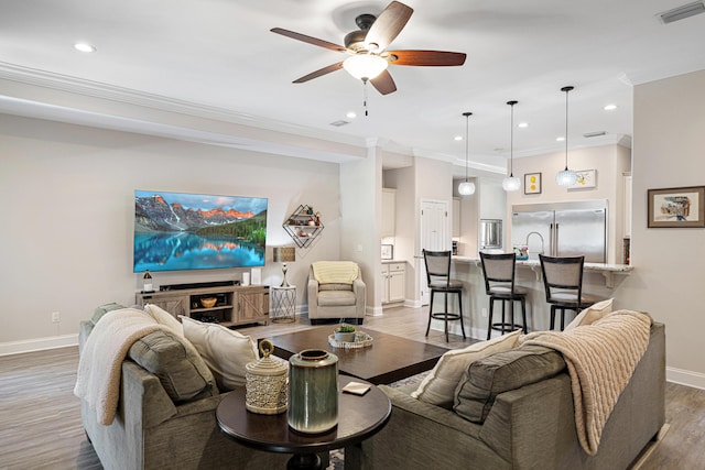 living area featuring visible vents, baseboards, ceiling fan, recessed lighting, and light wood-type flooring