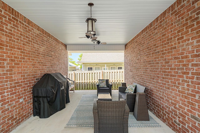 view of patio with ceiling fan and fence