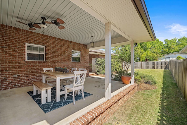 view of patio featuring outdoor dining area, a fenced backyard, and ceiling fan