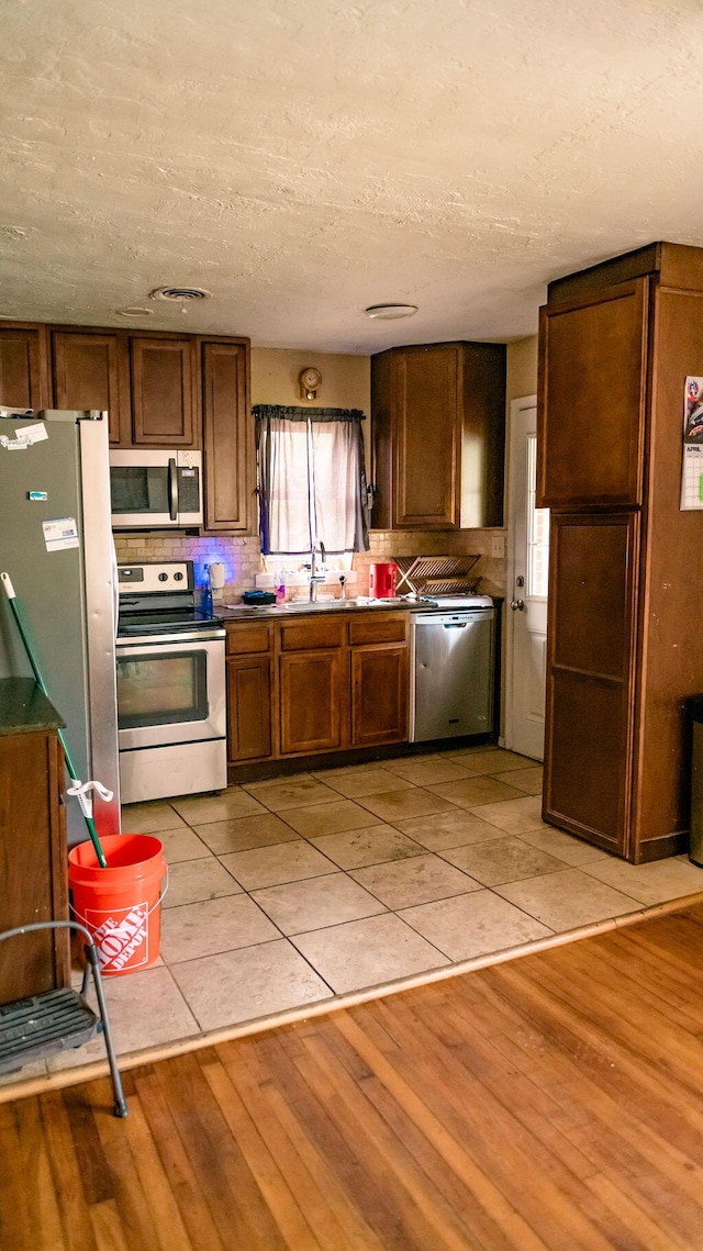 306 N 58th Ave, Pensacola, FL 32506 - kitchen featuring a wealth of natural light, appliances with stainless steel finishes, light wood-style floors, and a sink