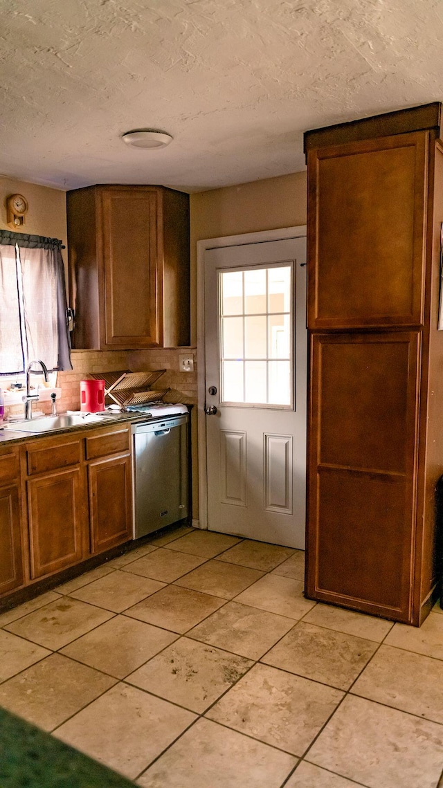 306 N 58th Ave, Pensacola, FL 32506 - kitchen featuring a sink, tasteful backsplash, light tile patterned flooring, a textured ceiling, and dishwasher
