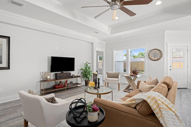 213 N Wells St, Panama City Beach, FL 32413 - living area featuring ornamental molding, a raised ceiling, visible vents, a ceiling fan, and wood finished floors
