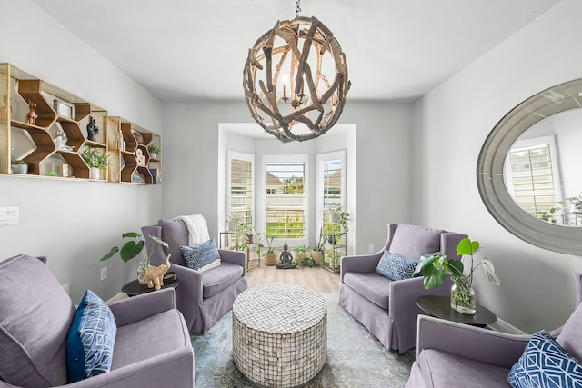 living room with a notable chandelier and wood finished floors