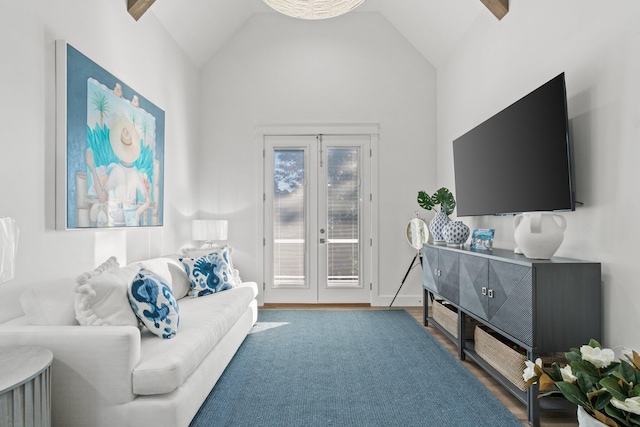 living area with french doors, lofted ceiling, and wood finished floors