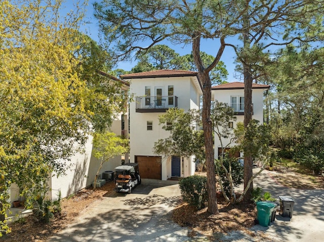 10 Mar A Lago Blvd # 14, Santa Rosa Beach, FL 32459 - mediterranean / spanish house featuring a tile roof, a balcony, concrete driveway, an attached garage, and stucco siding