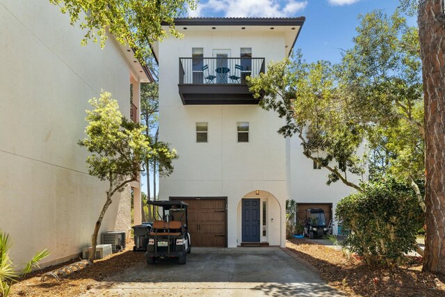 10 Mar A Lago Blvd # 14, Santa Rosa Beach, FL 32459 - rear view of property featuring central AC, a garage, stucco siding, a balcony, and driveway
