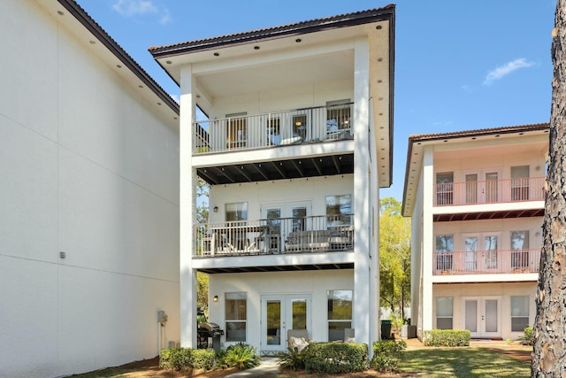 10 Mar A Lago Blvd # 14, Santa Rosa Beach, FL 32459 - back of property with a balcony, stucco siding, french doors, and cooling unit