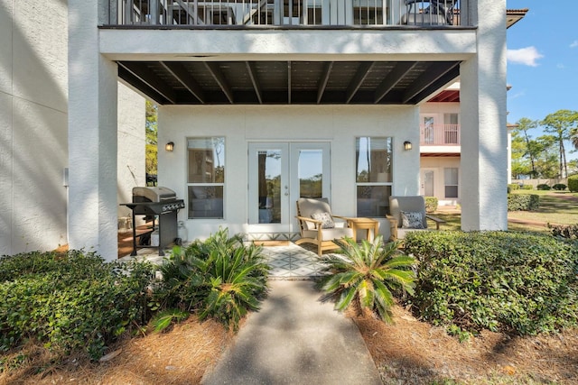 10 Mar A Lago Blvd # 14, Santa Rosa Beach, FL 32459 - property entrance featuring a balcony, stucco siding, and french doors