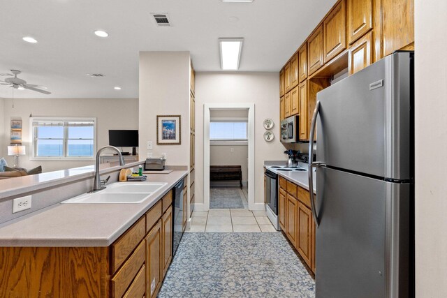 17 Fort Panic Rd, Santa Rosa Beach, FL 32459 - kitchen with light tile patterned flooring, visible vents, brown cabinets, appliances with stainless steel finishes, and a sink