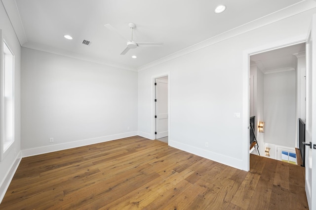unfurnished room with crown molding, ceiling fan, visible vents, recessed lighting, and wood-type flooring