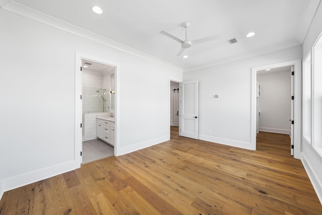 unfurnished bedroom featuring light wood-type flooring, ornamental molding, a spacious closet, recessed lighting, and visible vents