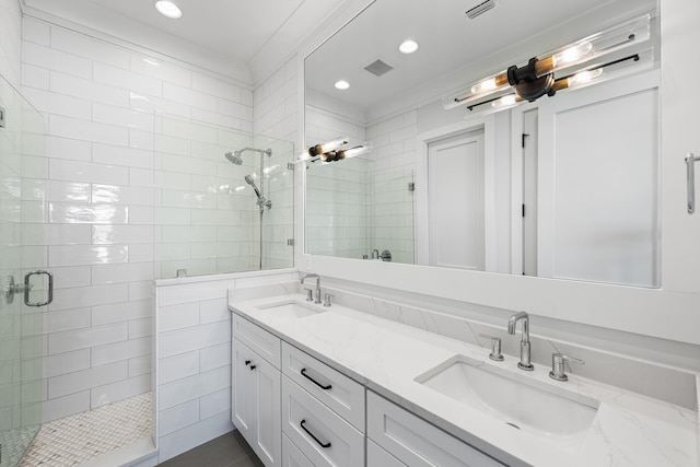 full bath featuring visible vents, a sink, and a stall shower