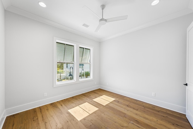 unfurnished room with visible vents, baseboards, ceiling fan, hardwood / wood-style flooring, and crown molding