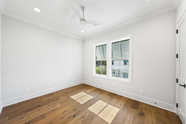 unfurnished room with crown molding, hardwood / wood-style floors, ceiling fan, and baseboards
