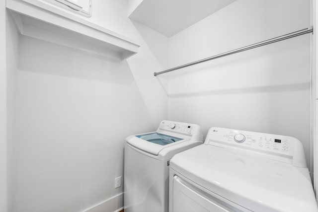 washroom with separate washer and dryer and laundry area