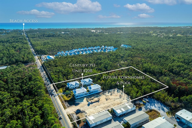 bird's eye view with a wooded view and a water view