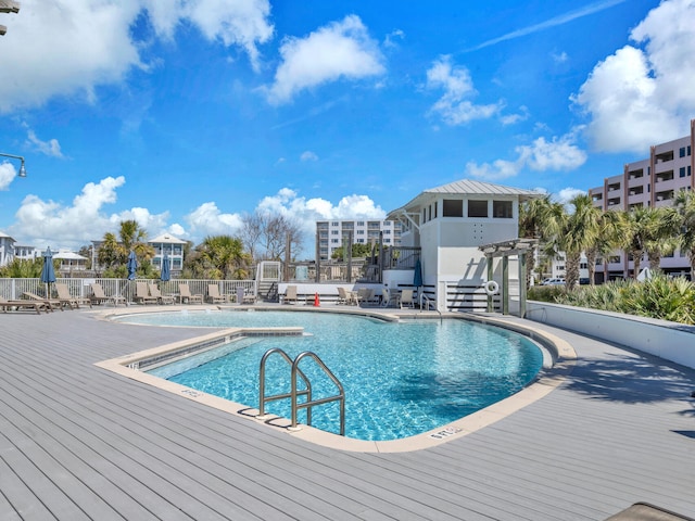 pool featuring fence and a patio area