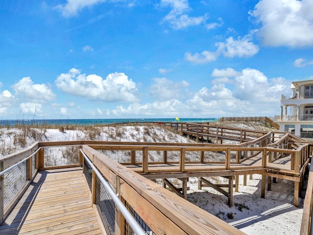 view of dock featuring a view of the beach and a water view