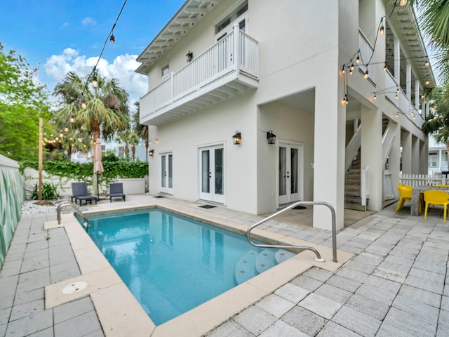 view of pool featuring a fenced backyard, a fenced in pool, french doors, and a patio